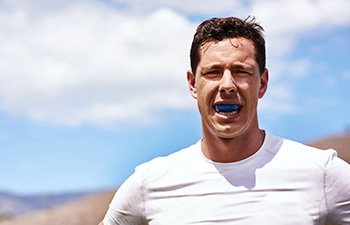 Man with blue mouthguard