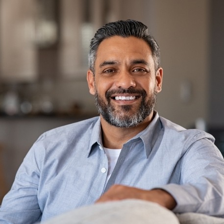 Smiling man sitting on couch