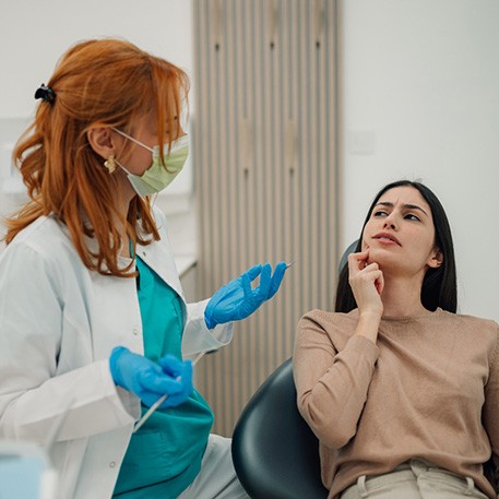 Concerned woman talking to her dentist about gum disease