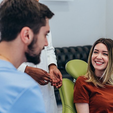 Smiling patient interacting with her dentist